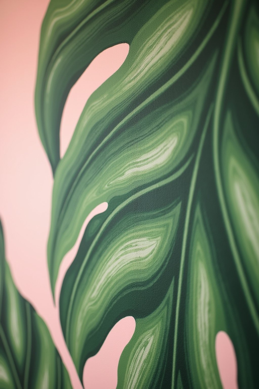 Close-up of hand-painted botanical mural detail on wall, showing brush strokes on painted monstera leaf with multiple green shades creating depth, veins visible, soft pink wall background, artistic...